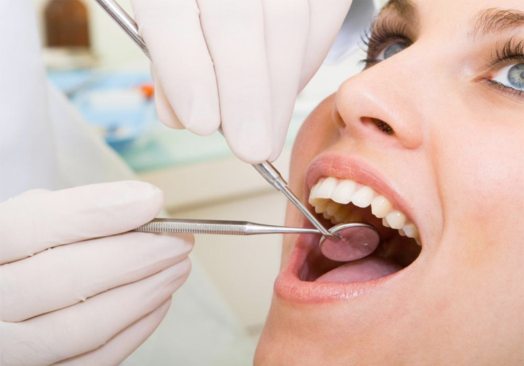 Closeup of a woman having her teeth examined