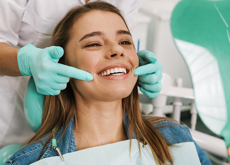 Smiling woman having her teeth examined